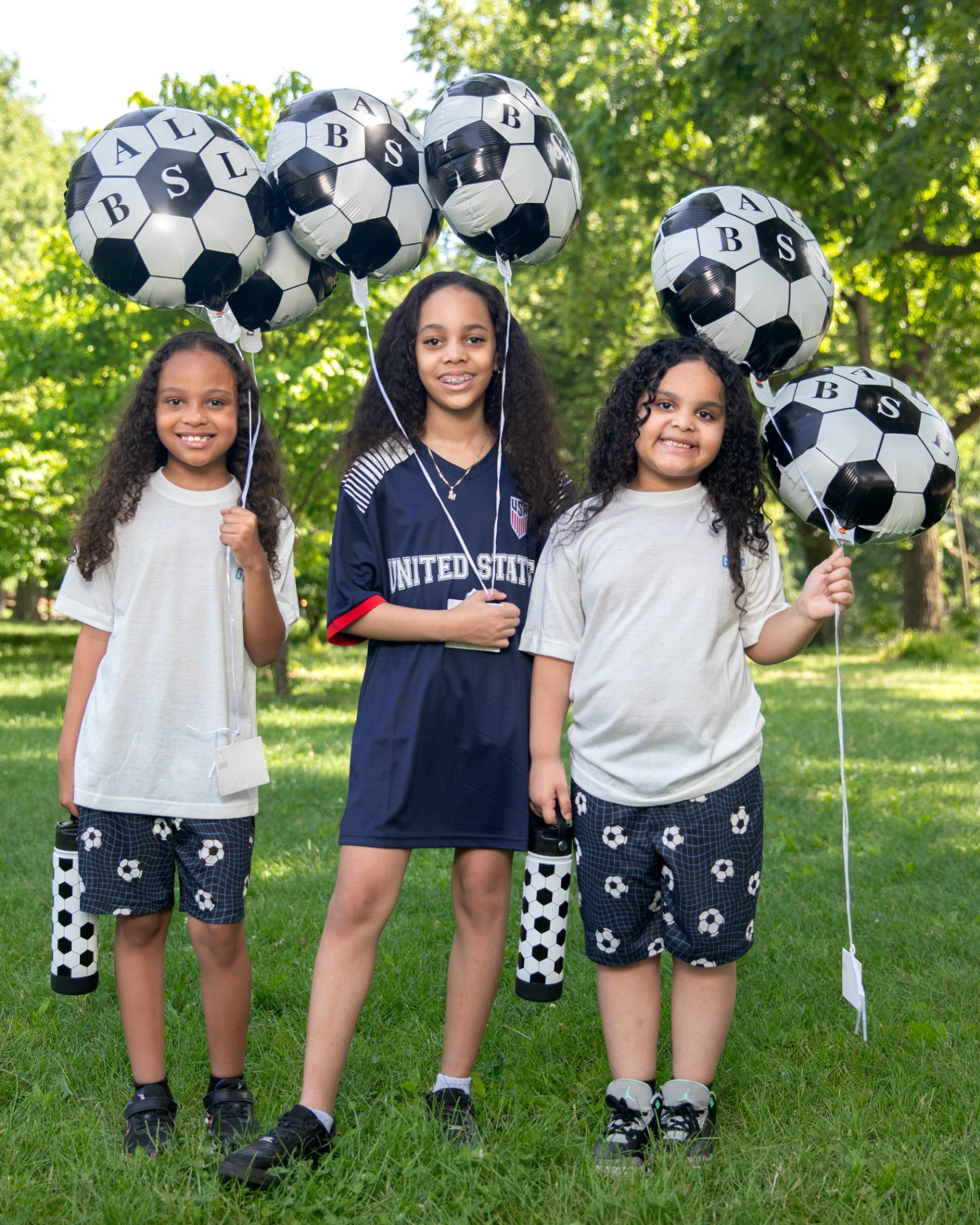 Squad lineup with soccer balloons and water bottles
